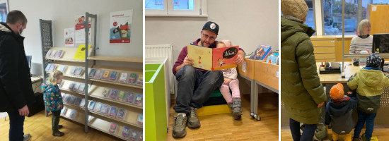 Vater und Kind suchen Bücher aus. Familie an der Ausleihe.